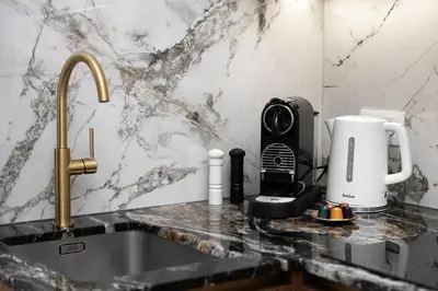 a kitchen counter with a sink and a coffee maker at Old Town K34 by M Apartments in Kraków