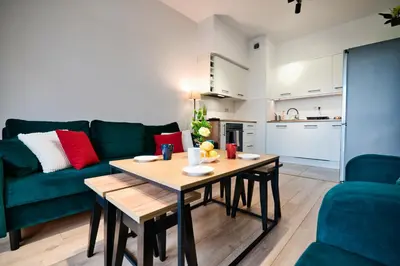 a living room with a table and a green couch at Dolce Vita by Housine in Zator