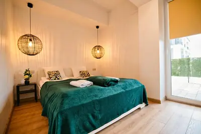 a bedroom with a bed with a green blanket at Dolce Vita by Housine in Zator