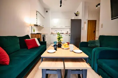 a living room with a green couch and a table at Dolce Vita by Housine in Zator