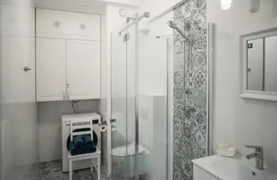 a white bathroom with a shower and a sink at Apartament Róża 2 Zator - 2km od Energylandii in Zator