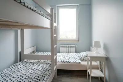 a childs bedroom with bunk beds and a window at Apartament Róża 2 Zator - 2km od Energylandii in Zator