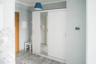 a hallway with a mirror and a chair in a room at Apartament Róża 2 Zator - 2km od Energylandii in Zator