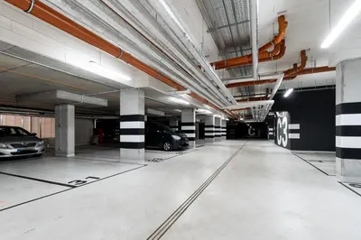 an empty parking garage with cars parked in it at Saska Park Apartments in Kraków