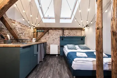 a bedroom with a bed and a sink in a room at Kazimierz District - Dietla 51 street in Kraków