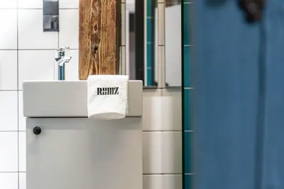 a bathroom with a white sink and a towel at Kazimierz District - Dietla 51 street in Kraków