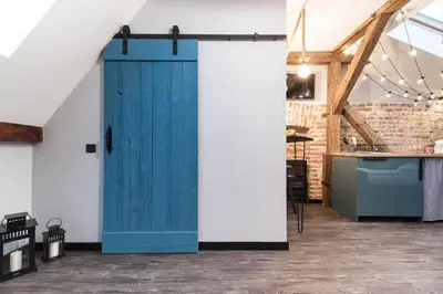 a blue door in the middle of a room at Kazimierz District - Dietla 51 street in Kraków