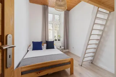 a white bathroom with a toilet and a washing machine at 3-bedroom apartment - 51 Dietla street in Kraków
