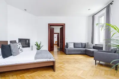 a living room with a bed and a couch at Two Bedroom Apartment - Dietla 51 street in Kraków