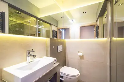 a bathroom with a sink and a toilet at RentPlanet - Apartament Prusa in Kraków