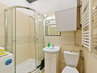a bathroom with a toilet and a shower and a sink at 2-bedroom apartment - 51 Dietla Street in Kraków