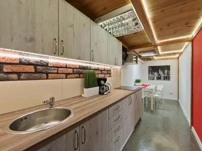 a kitchen with a sink and a brick wall at 2-bedroom apartment - 51 Dietla Street in Kraków