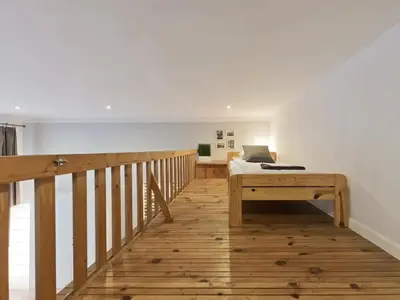 a bedroom with a bed and a wooden floor at 2-bedroom apartment - 51 Dietla Street in Kraków