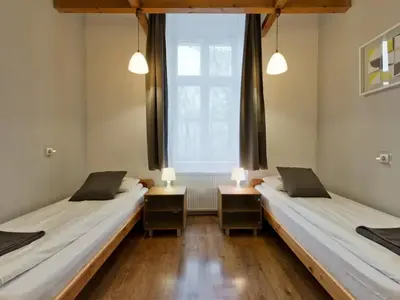 two beds in a room with a window at 2-bedroom apartment - 51 Dietla Street in Kraków