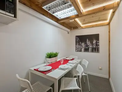a dining room with a white table and chairs at 2-bedroom apartment - 51 Dietla Street in Kraków