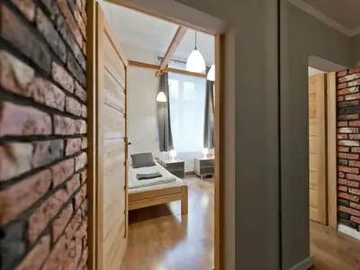 a room with a couch and a brick wall at 2-bedroom apartment - 51 Dietla Street in Kraków
