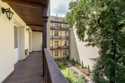 an external balcony of a building with a wooden deck at One bedroom apartment in the centre - Sarego 16 in Kraków