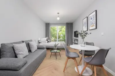 a living room with a couch and a table at Apartment with balcony Kalwaryjska 34 street in Kraków