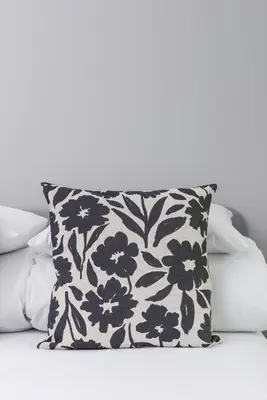 a black and white pillow sitting on a bed at Apartment with balcony Kalwaryjska 34 street in Kraków