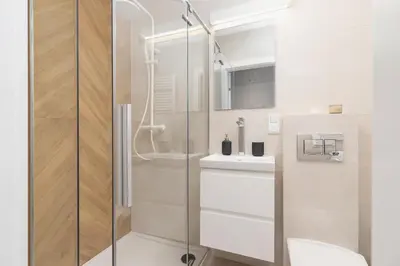 a bathroom with a shower and a toilet and a sink at Apartment with balcony Kalwaryjska 34 street in Kraków