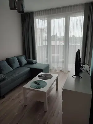 a living room with a couch and a coffee table at Apartamenty przy Mogilskiej z miejscem postojowym in Kraków