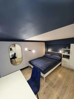 a bedroom with a bed and a mirror at Przystań na Kazimierzu in Kraków