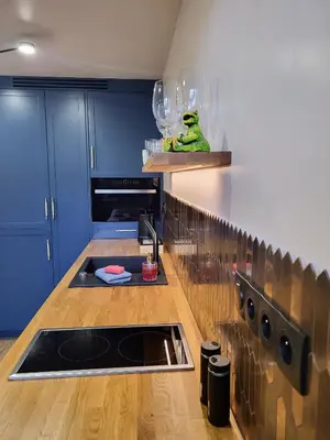 a kitchen with blue cabinets and a counter with a sink at Przystań na Kazimierzu in Kraków