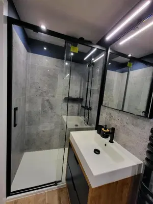 a bathroom with a white sink and a shower at Przystań na Kazimierzu in Kraków