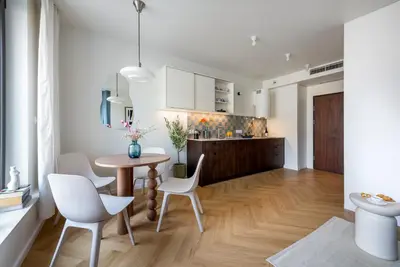 a kitchen and dining room with a table and chairs at Wawel View Stylish Apartment - Kościuszki 22 in Kraków