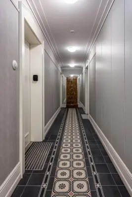 a corridor with a tile floor in a hallway at Wawel View Stylish Apartment - Kościuszki 22 in Kraków