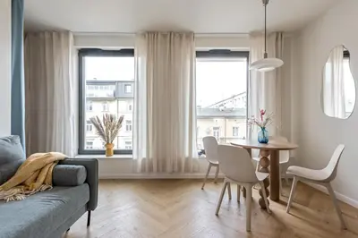 a living room with a couch and a table at Wawel View Stylish Apartment - Kościuszki 22 in Kraków