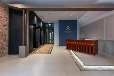 a hallway of a building with a sign on the wall at Wawel View Stylish Apartment - Kościuszki 22 in Kraków