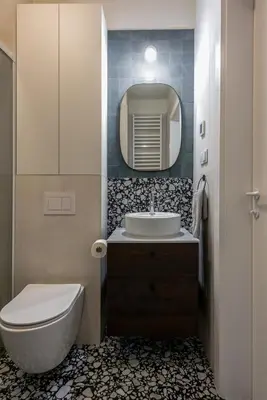 a bathroom with a sink and a toilet and a mirror at Wawel View Stylish Apartment - Kościuszki 22 in Kraków