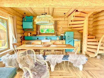 a dining room with a table and chairs in a cabin at Bale na Skale Chata & SPA-Zawoja in Skawica