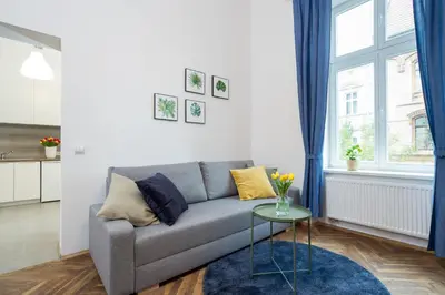 a living room with a couch and a table at Apartment with City View - Dietla 68 street in Kraków