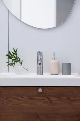a bathroom counter with a mirror and a sink at One Bedroom Apartment - Dietla 68 street in Kraków