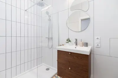 a bathroom with a shower and a sink and a mirror at One Bedroom Apartment - Dietla 68 street in Kraków