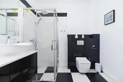 a bathroom with a shower and a toilet and a sink at Studio Apartment - Dietla 109 street in Kraków