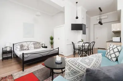 a living room with a bed and a table at Studio Apartment - Dietla 109 street in Kraków
