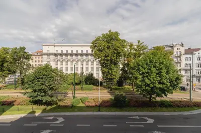 an empty street in front of a large building at Studio Apartment - Dietla 109 street in Kraków