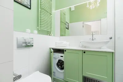 a bathroom with a sink and a washing machine at Apartment with balcony - Dietla 109 street in Kraków
