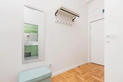 a bathroom with a mirror and a sink at Apartment with balcony - Dietla 109 street in Kraków