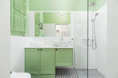 a green bathroom with a sink and a shower at Apartment with balcony - Dietla 109 street in Kraków