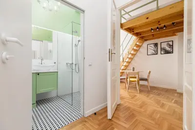a bathroom with a sink and a shower and a table at Apartment with balcony - Dietla 109 street in Kraków
