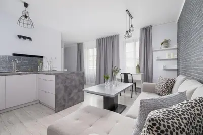 a living room with a couch and a table at One Bedroom Apartment with a Balcony - Dietla 109 street in Kraków