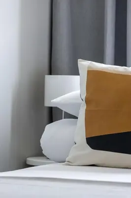 a pile of pillows sitting on top of a bed at 3-bedroom apartment - Old Town- Blich 9 in Kraków