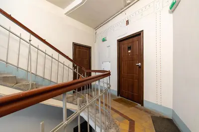 a hallway with stairs and a wooden door at 3-bedroom apartment - Old Town- Blich 9 in Kraków