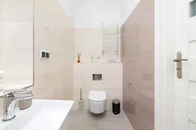 a white bathroom with a toilet and a sink at 3-bedroom apartment - Old Town- Blich 9 in Kraków