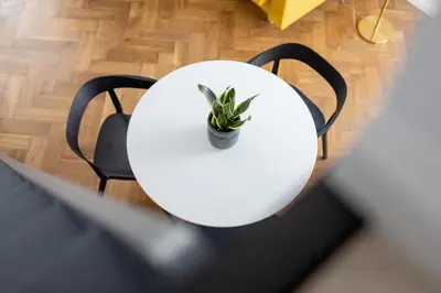 a white table and chairs with a plant on it at Main Square - Modern Apartment - 7 Gertrudy street in Kraków