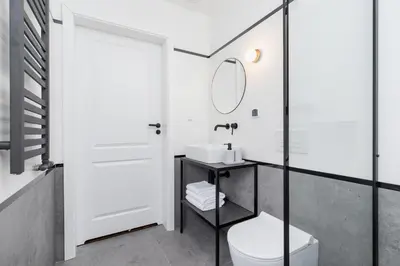a bathroom with a toilet and a mirror at Main Square - Modern Apartment - 7 Gertrudy street in Kraków